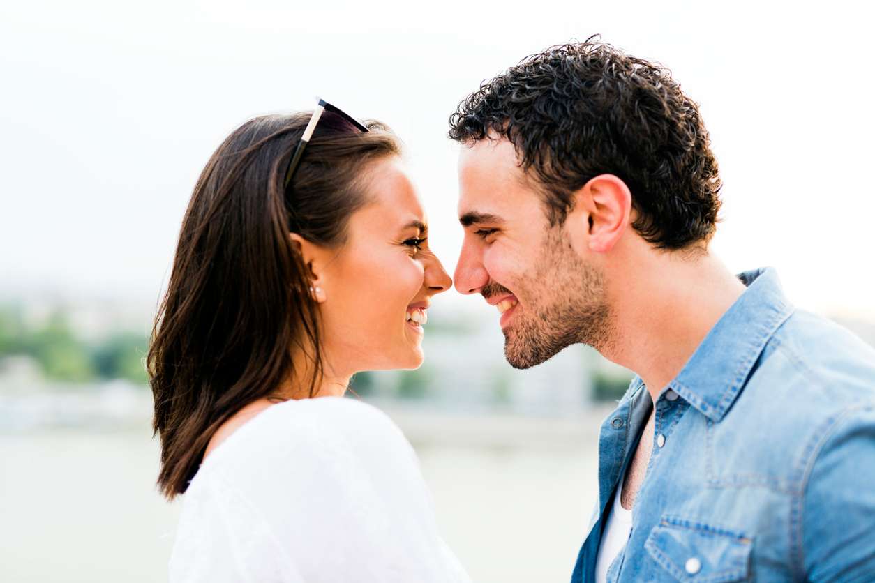 man and woman laughing at each other